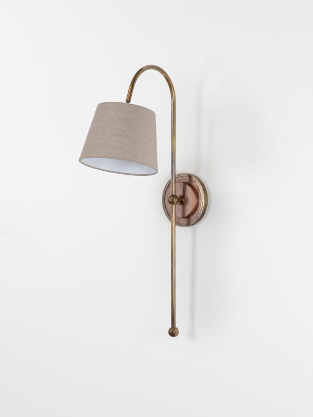 Arched wall light made from brass tubing and walnut accents with circular back plate and linen shade - Light off.