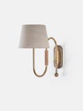 Curved wall light made from brass tubing and walnut accents with a thumb-turn switch and linen shade.
